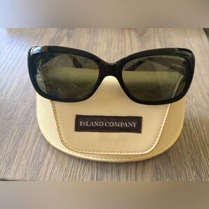 The Island Company Swinging 60 Sunglasses S1104P feature black frame and glasses